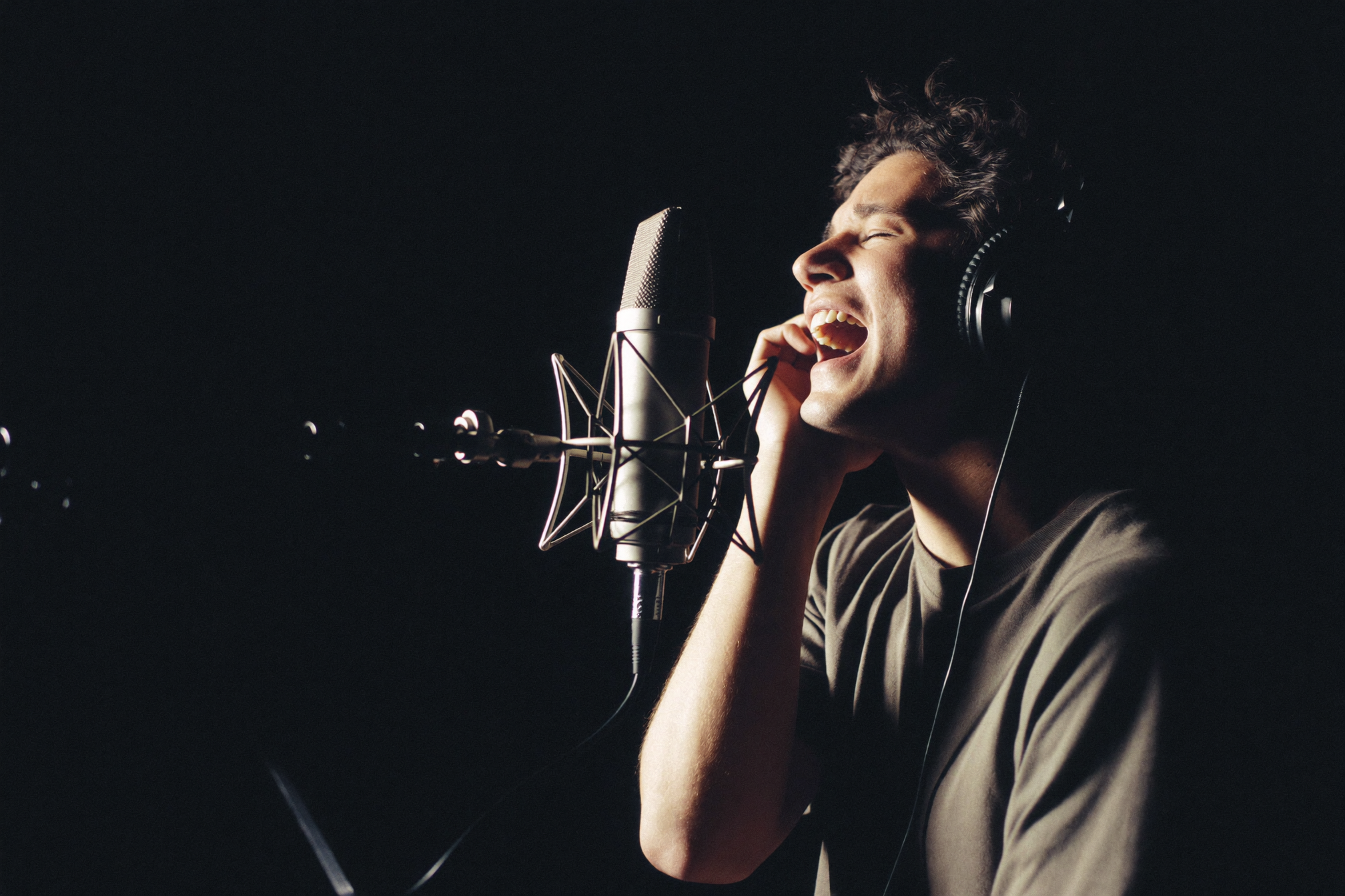 Vocalist recording in booth